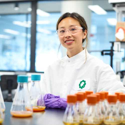 A photo of a Bioworker sitting at lab bench waiting for you to contact Ginkgo